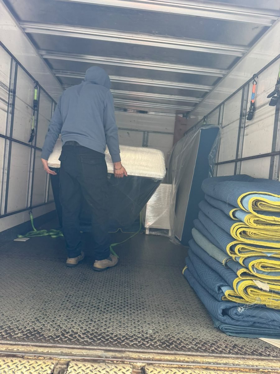 Inside the Sam's Removals truck — wrapped furniture secured with padded blankets